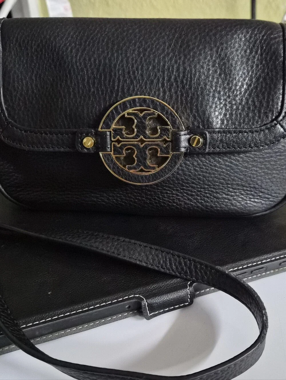 The item shown in the listing is the Tory Burch Amanda Foldover Crossbody Bag.